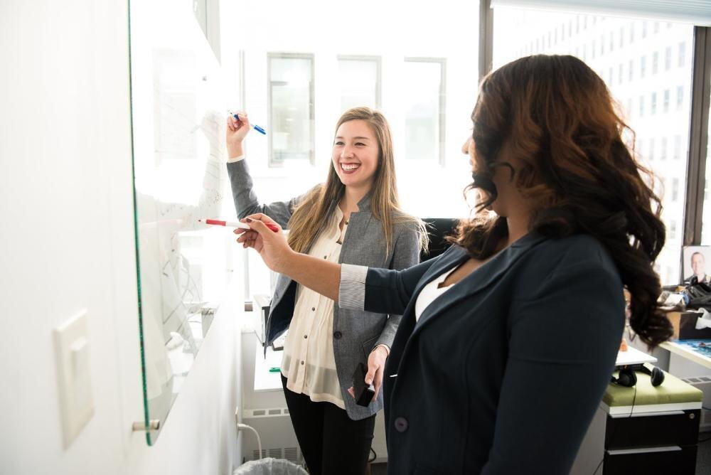 Women Writing on a Board