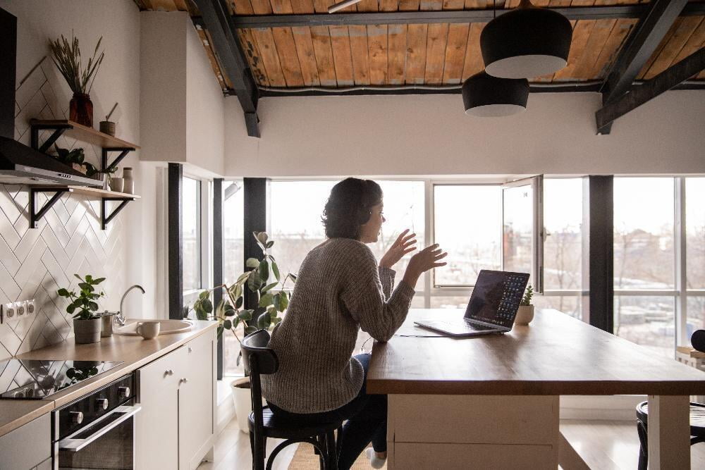 Woman Working on Laptop in the Kitchen